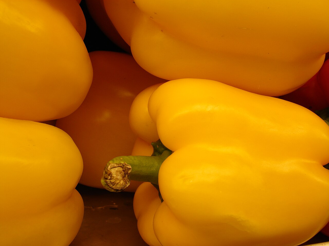 Спелые жёлтые толстостенные плоды сладкого перца Capsicum annuum, лежащие на прилавке